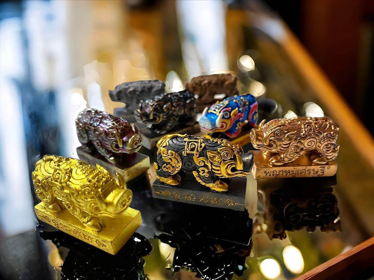 Phaya Moo Setthi - Luang Por Whan ornate Thai pig amulets in gold black and multicolor for home shrine and feng shui