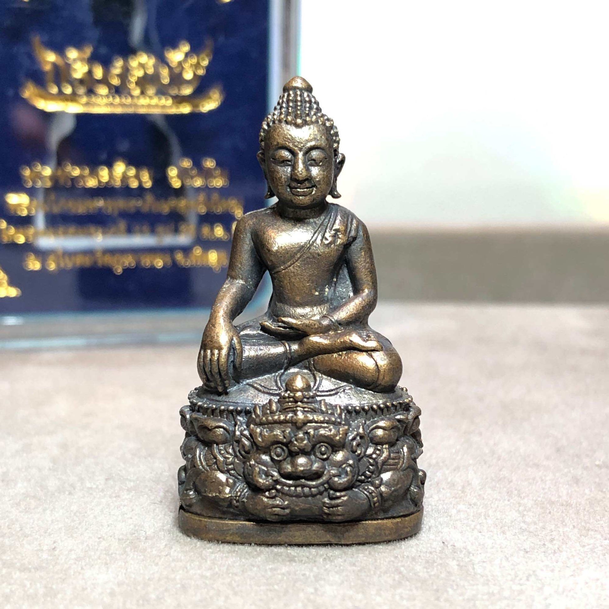 Phra Kring Srivichai amulet bronze seated Buddha on ornate mythic demon pedestal devotional talisman
