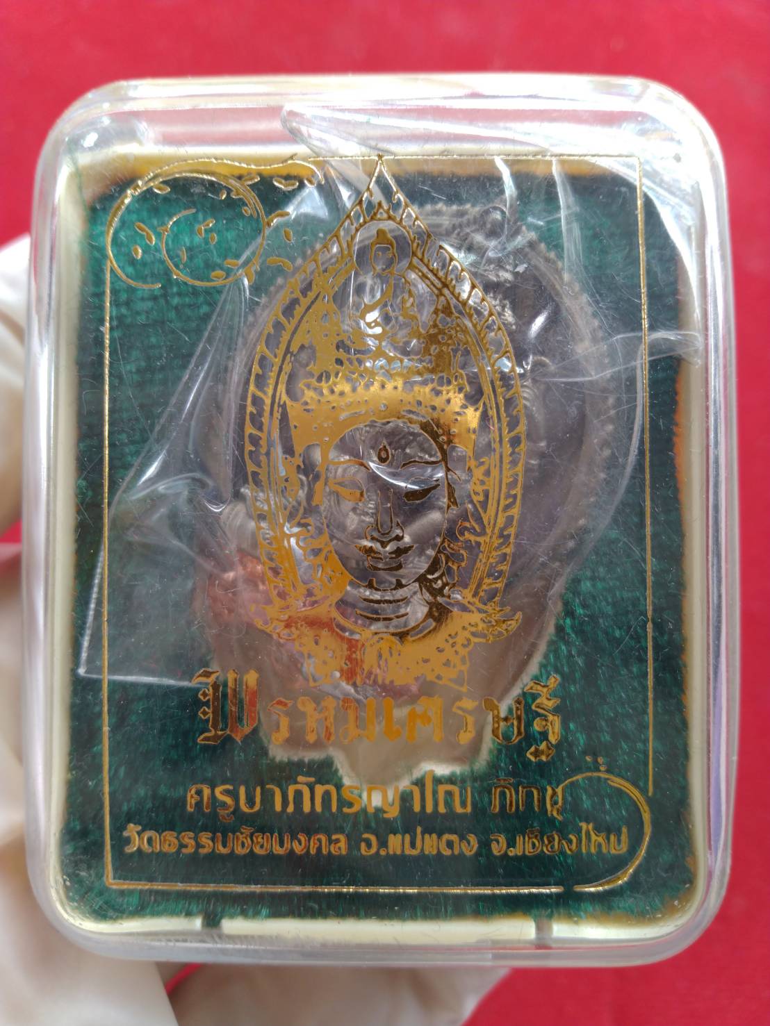 Phra Phrom Sethi amulet for wealth pendant in a clear plastic case with gold embossed green box
