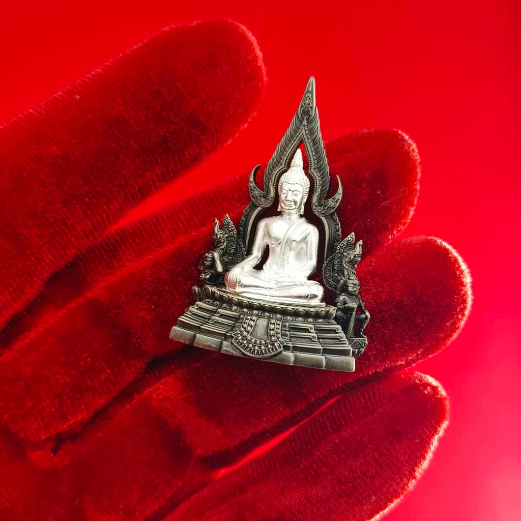 Phra Phuttha Chinnarat amulet silver Buddha pendant on ornate throne held on red velvet glove by Thai Blessing Co