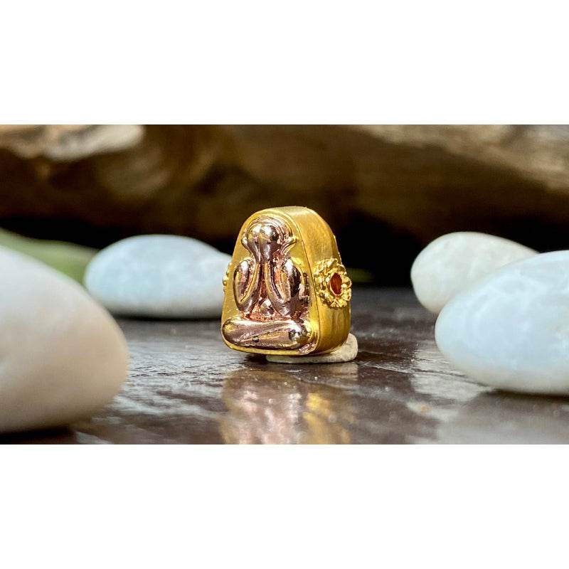Phra Pidta amulet for sale gilded Thai protective pendant with red gemstone and gold casing on white stones