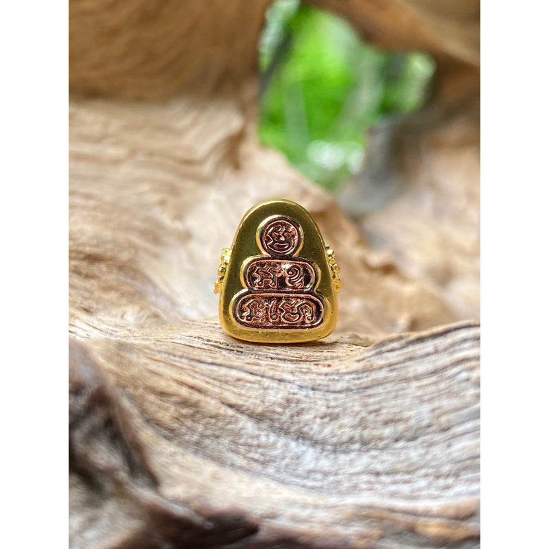Phra Pidta amulet for sale gold Thai amulet with engraved copper face on wooden display by Thai Blessing Co