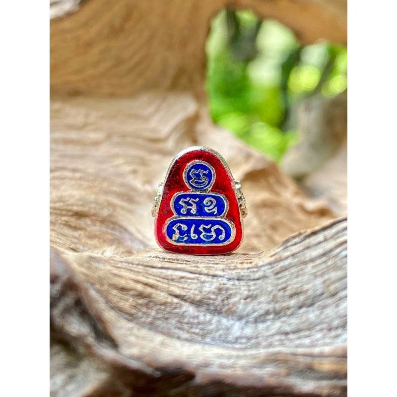 Thai Blessing Co Phra Pidta wealth amulet small red and blue enamel triangular Buddhist luck charm with Thai script