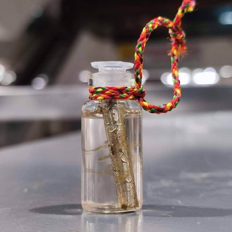 Thai attraction oil for love in small glass vial pendant with metal amulet and braided cord by Thai Blessing Co