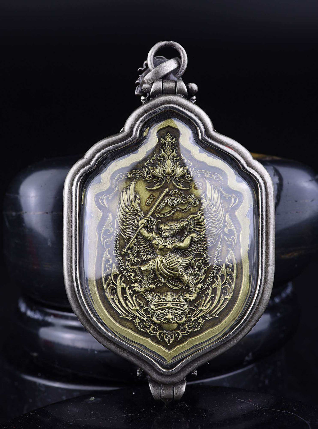 Ornate Thai metal pendant with embossed deity in glass case Thao Wessuwan amulet for protection