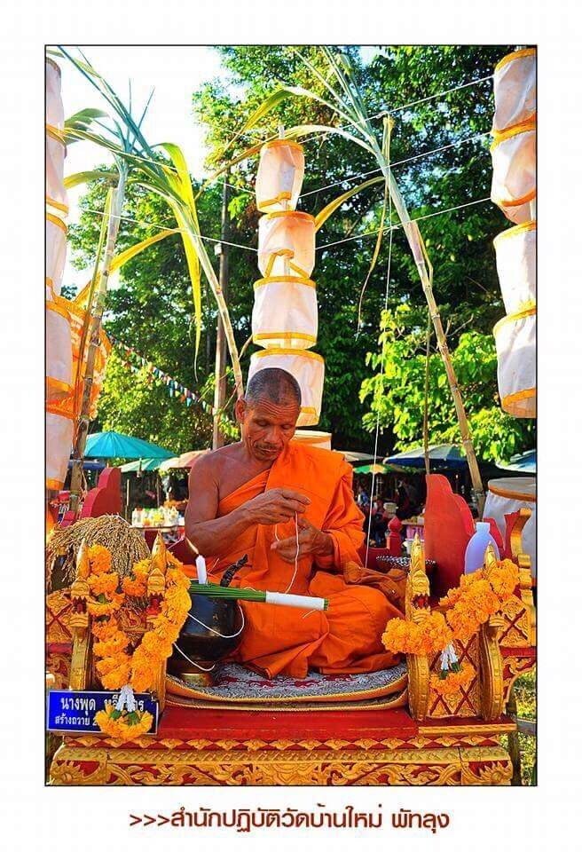 Thao Wessuwan Amulet bracelet crafted by a Thai monk in orange robes during ceremonial blessing