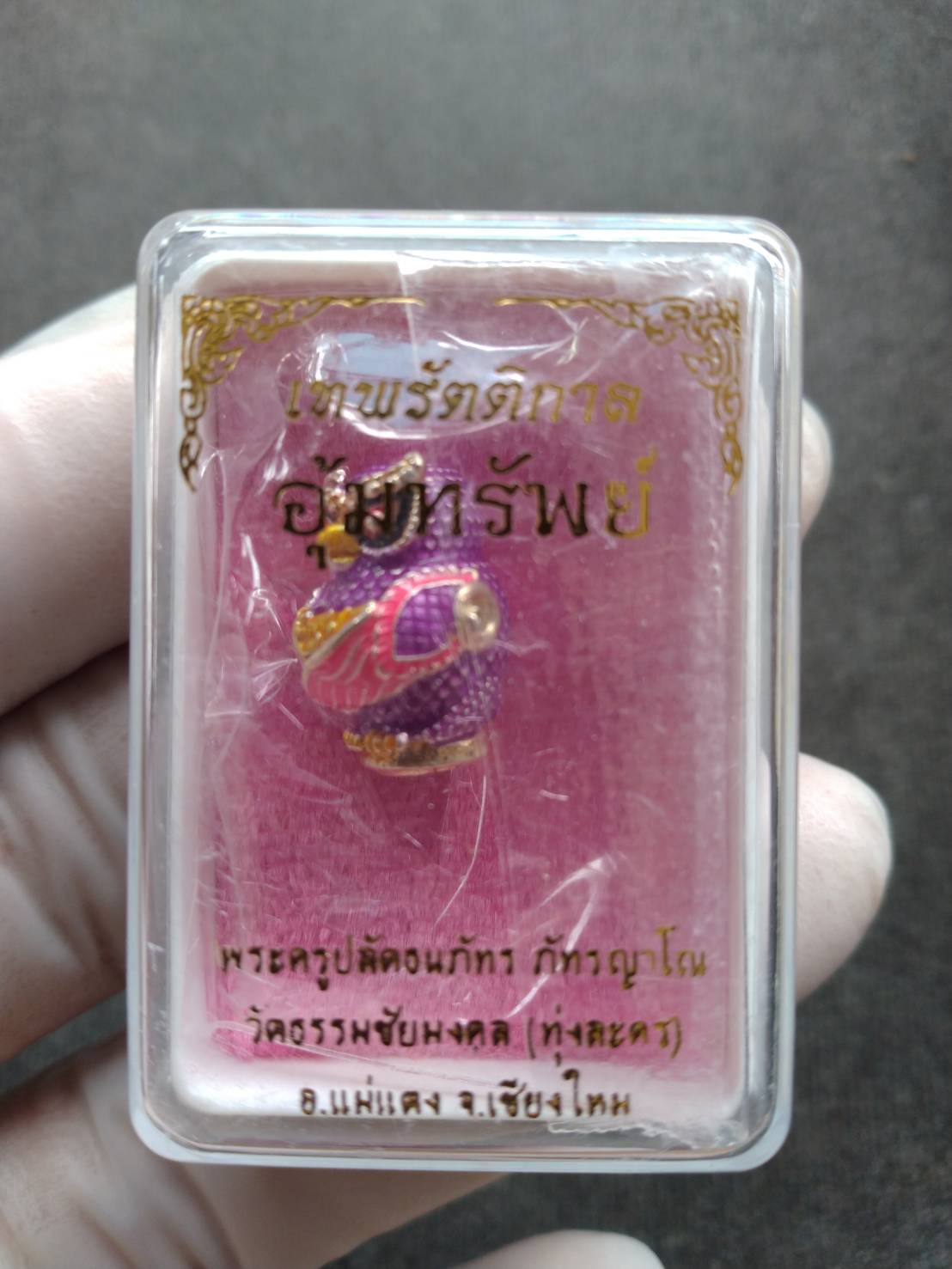 Thai Blessing Co Thep Rattikan oom sap amulet in clear plastic case pink backing gold purple pendant