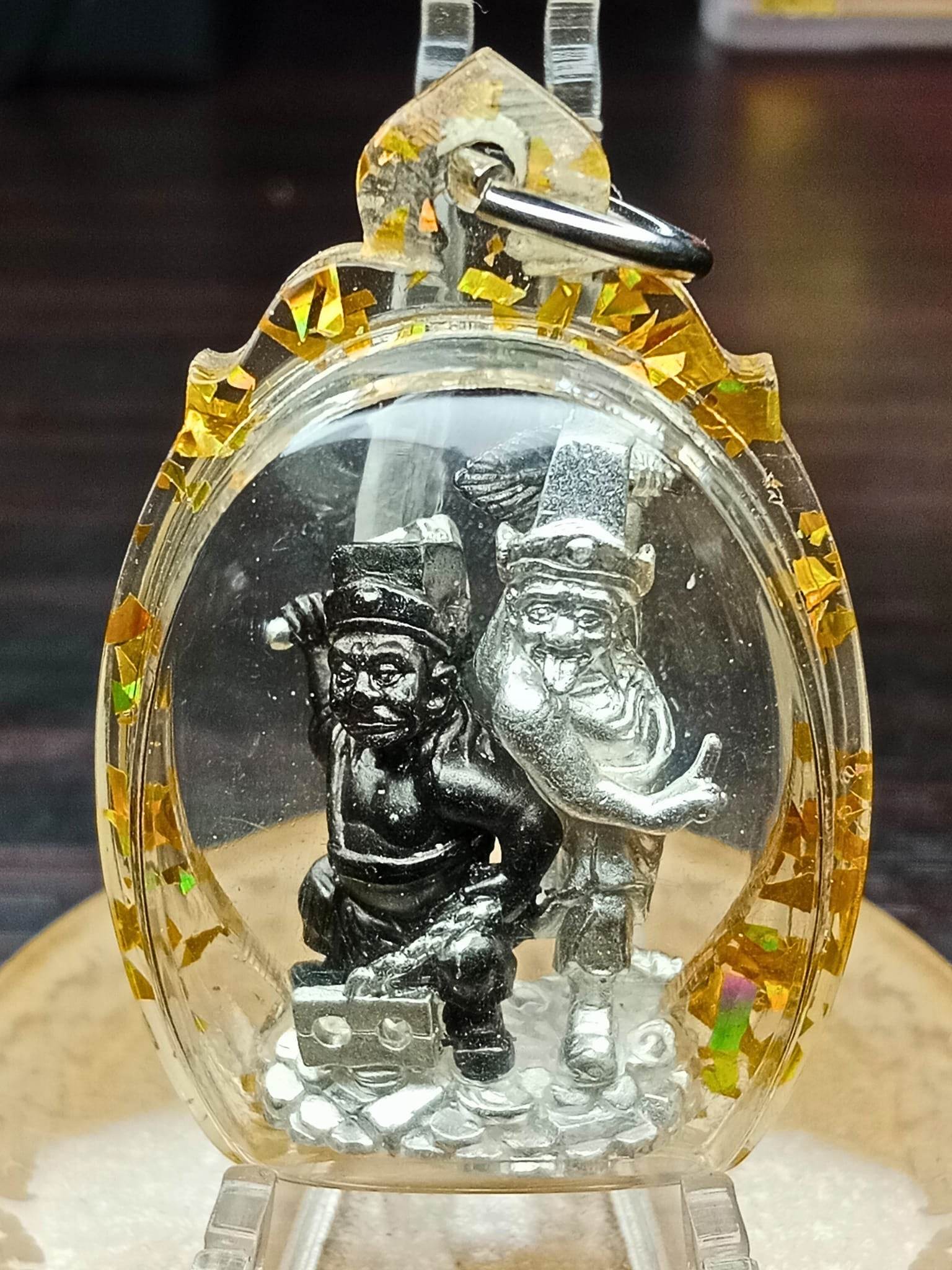 Tua Pae-Yee Pae Amulet - 2 Deities of Wealth silver figures in clear amulet case with gold flakes and metal keyloop