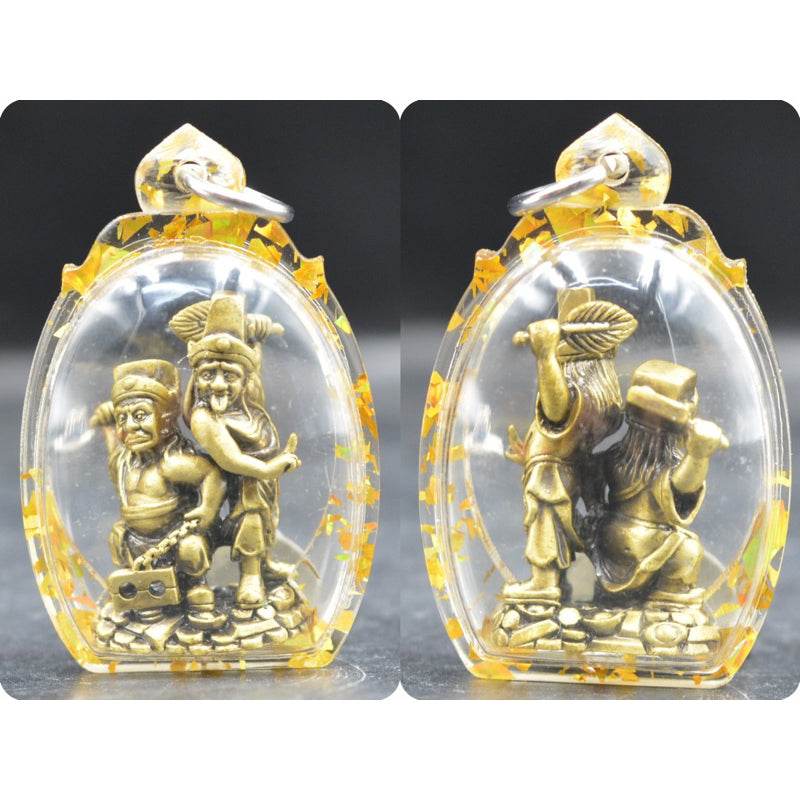 Tua Pae-Yee Pae Amulet - 2 Deities of Wealth clear casing showing two small gold deities standing on coins