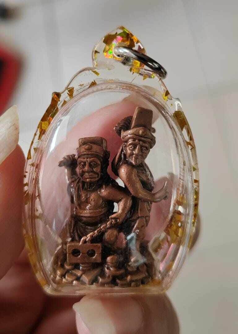 Tua Pae-Yee Pae Amulet - 2 Deities of Wealth small bronze twin deities in clear gold fleck plastic pendant case