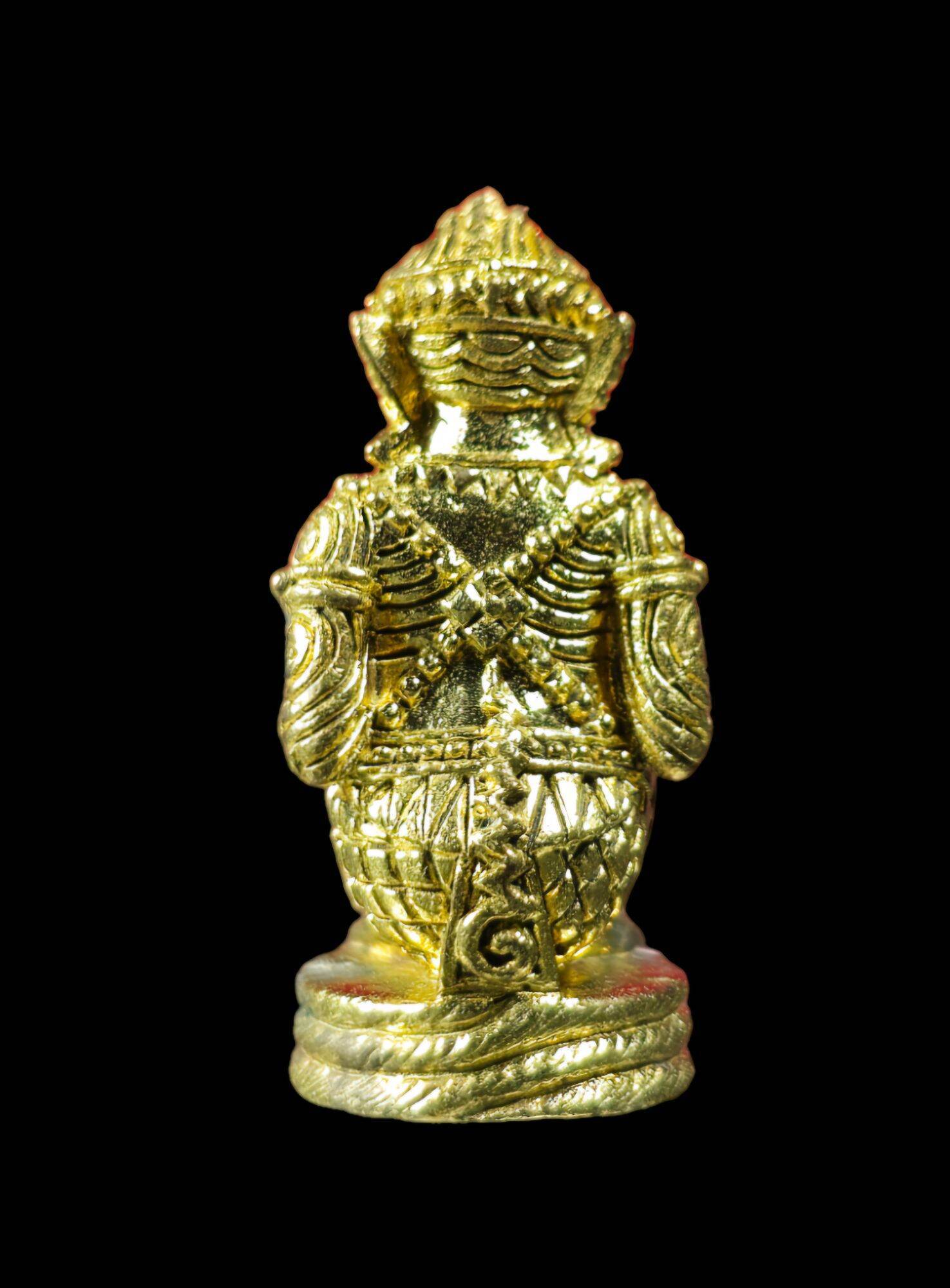 Gold miniature standing authentic Thai Hanuman amulet on black background showing engraved back details