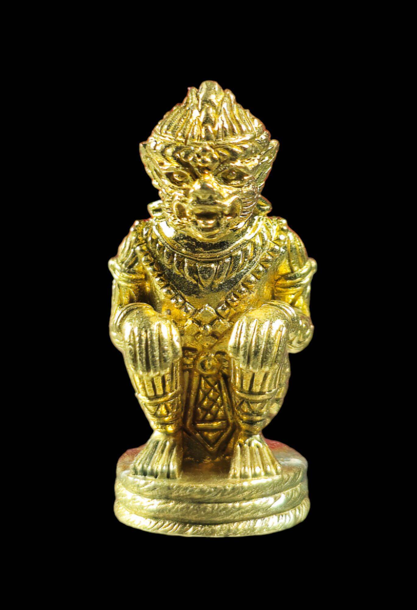 Gold metal figurine of seated Hanuman on pedestal with intricate carved details handcrafted authentic Thai Hanuman amulet