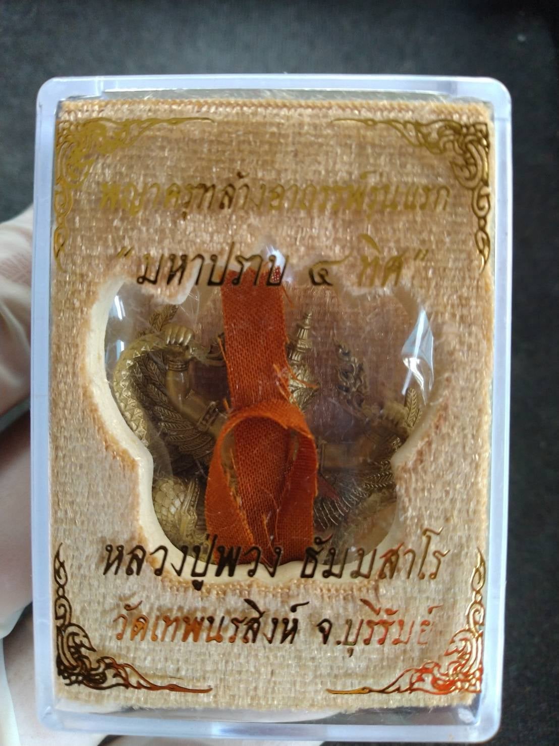 Phaya Krut Garuda Amulet in clear protective case with orange ribbon gold Garuda pendant Thai sacred talisman