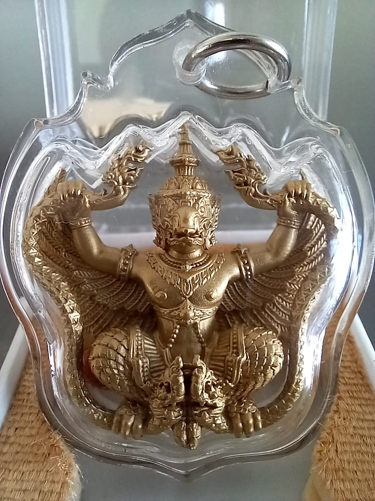 Phaya Krut Garuda Amulet gold tone Thai guardian pendant in clear protective casing detailed relief