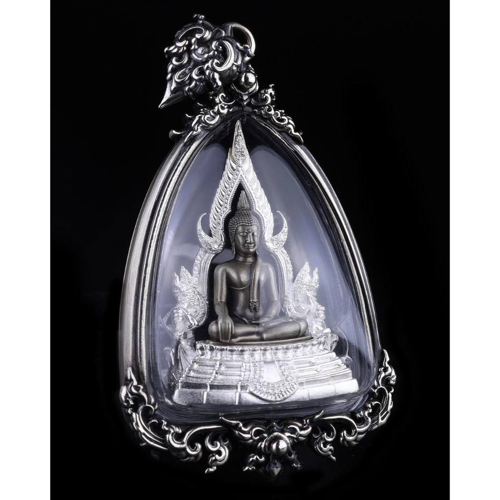 Phra Put Chinnarat amulet in ornate silver case with seated Buddha image and decorative Thai frame