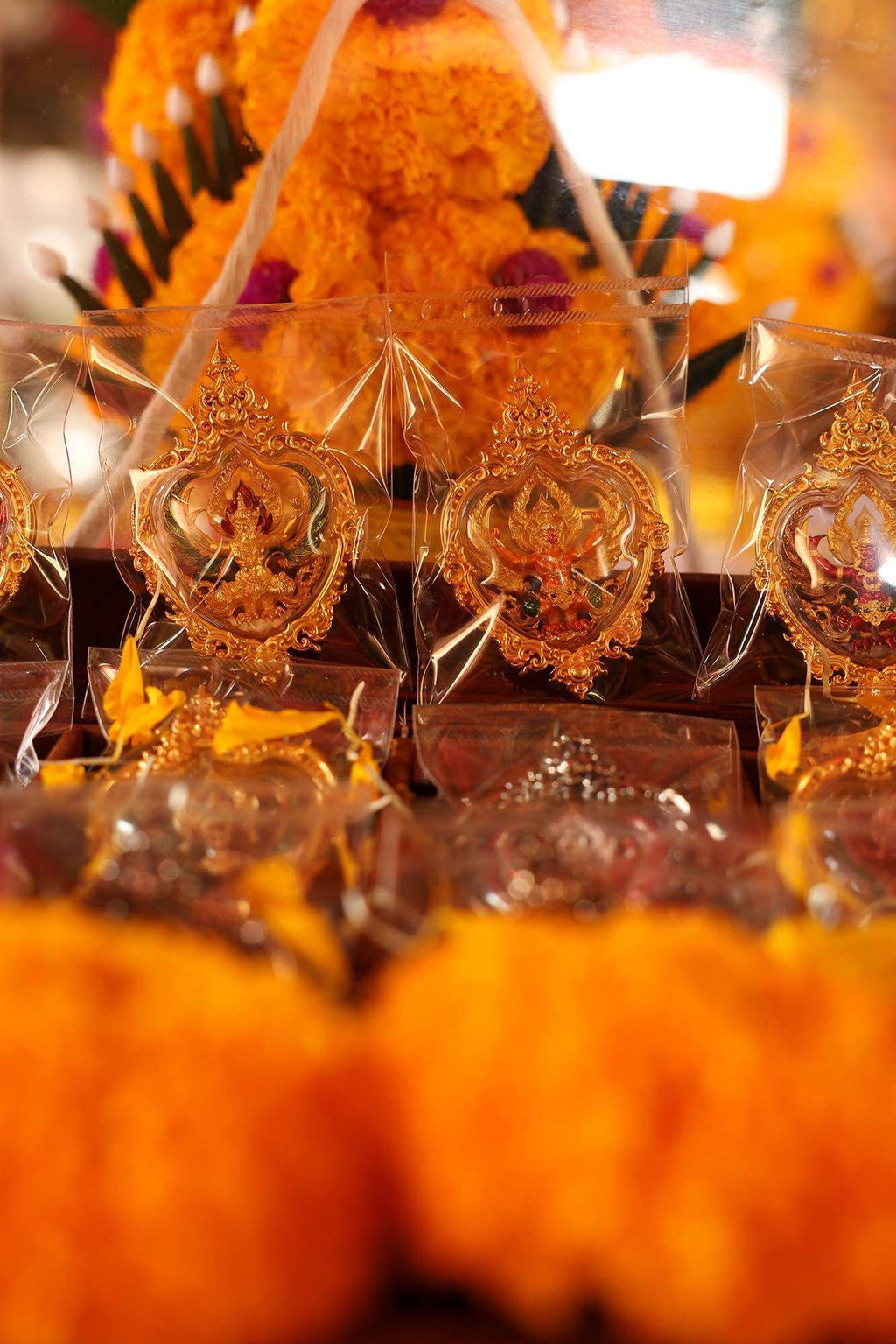 Thai Garuda car display amulet gold plated Garuda amulets in plastic packaging with marigold garlands