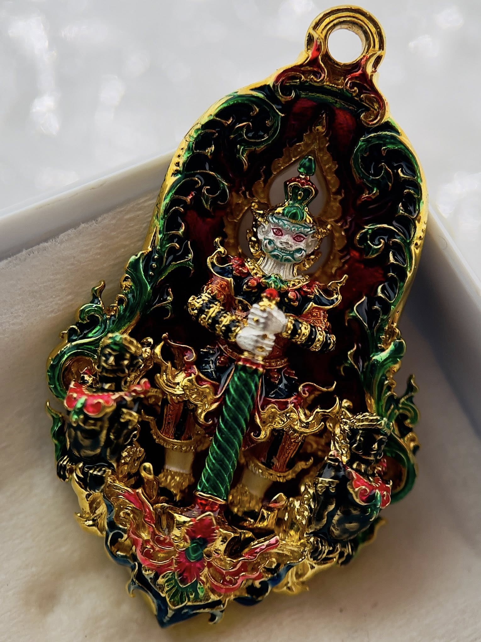 Thao Wessuwan amulet for protection with intricate design and vibrant colors in a decorative setting