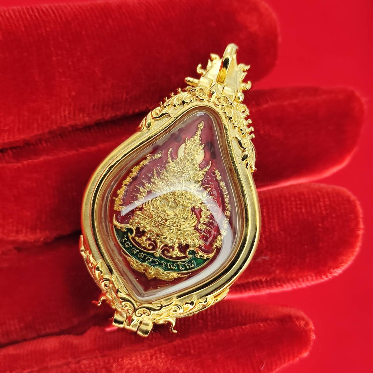 Thao Wessuwan amulet for protection with intricate gold frame and vibrant red details