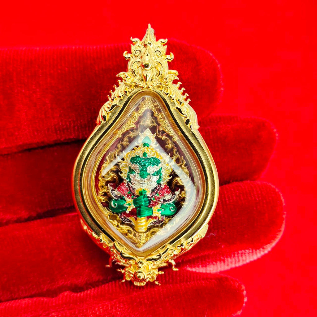 Thao Wessuwan amulet for protection in ornate gold casing with intricate details and colorful embellishments