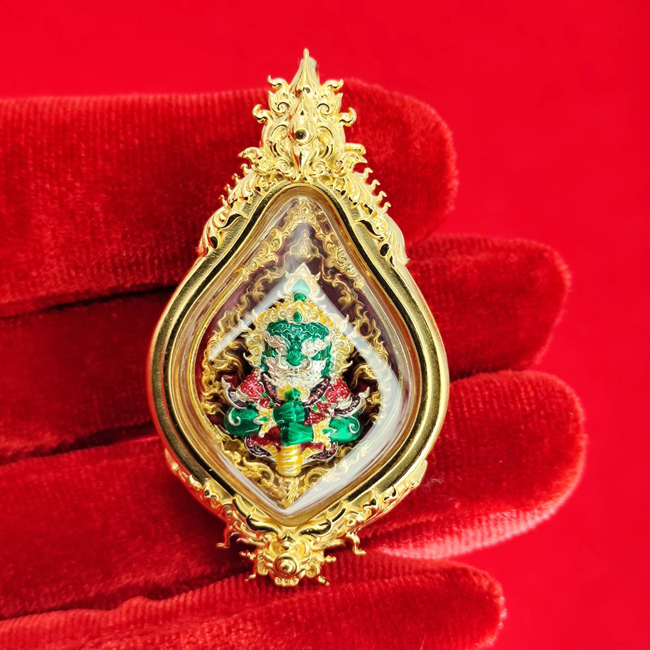 Thao Wessuwan amulet for protection in ornate gold casing with intricate details and colorful embellishments