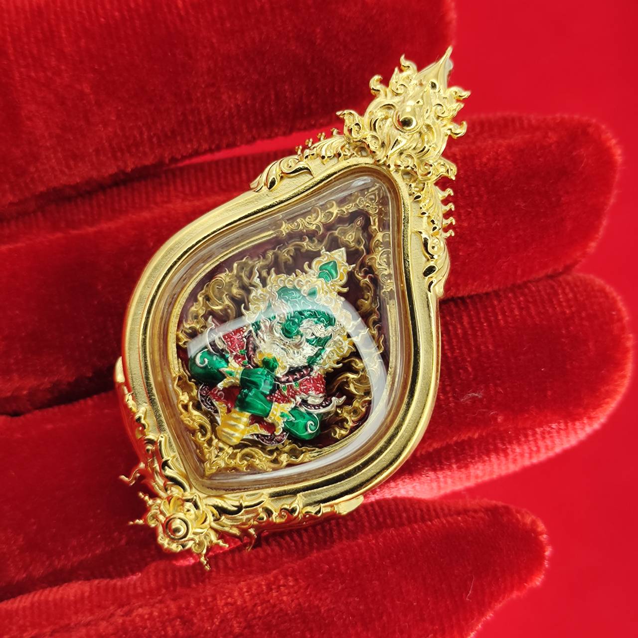 Thao Wessuwan amulet for protection encased in ornate gold frame with vibrant colors