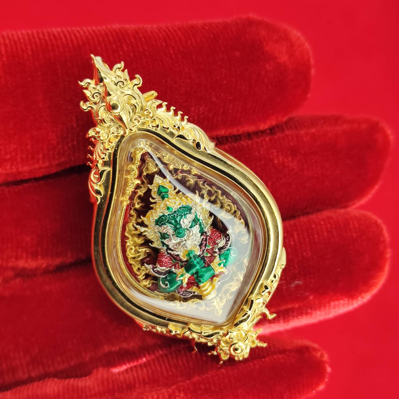 Thao Wessuwan amulet for protection in elegant casing, displayed on red velvet background by Thai Blessing Co