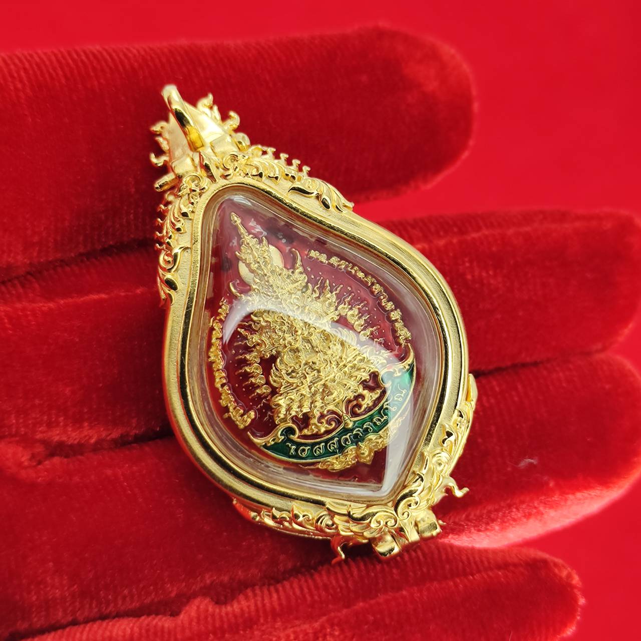 Thao Wessuwan amulet for protection in a gold pendant with intricate detailing and vibrant colors