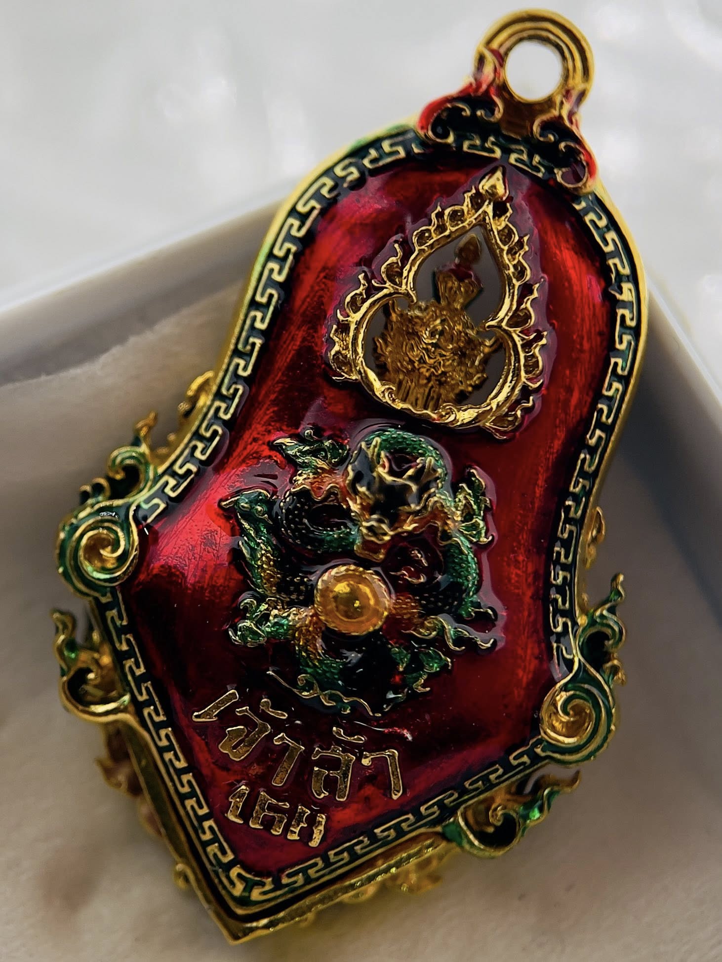 Thao Wessuwan amulet for protection with intricate red and gold detailing showcasing spiritual symbols