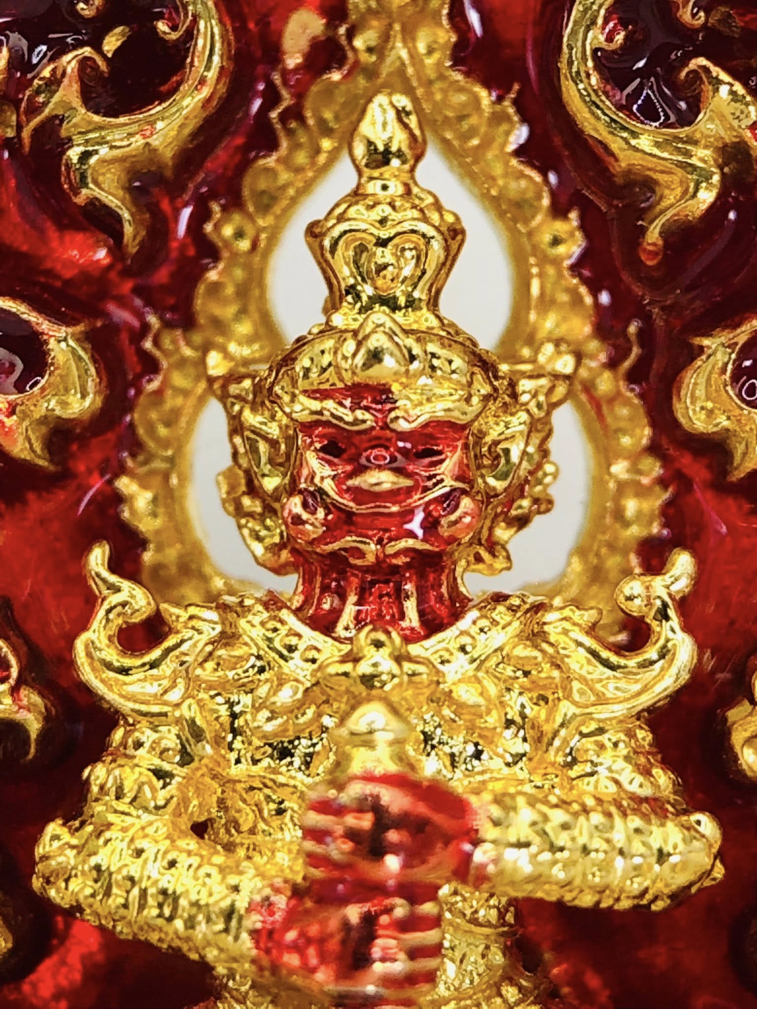Thao Wessuwan amulet for sale in vibrant red and gold with intricate details and craftsmanship