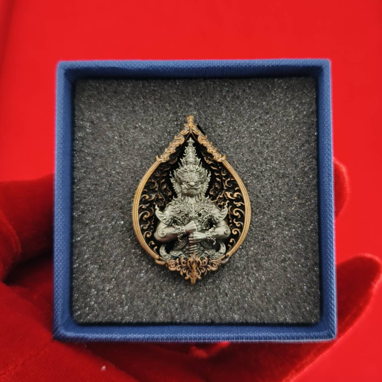 Thao Wessuwan amulet for wealth in an elegant display box with intricate detailing