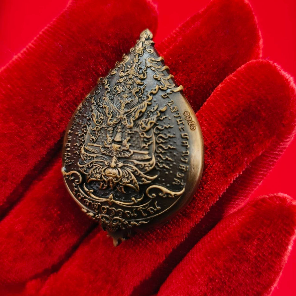 Thao Wessuwan amulet for wealth displayed on a red velvet background showcasing intricate details