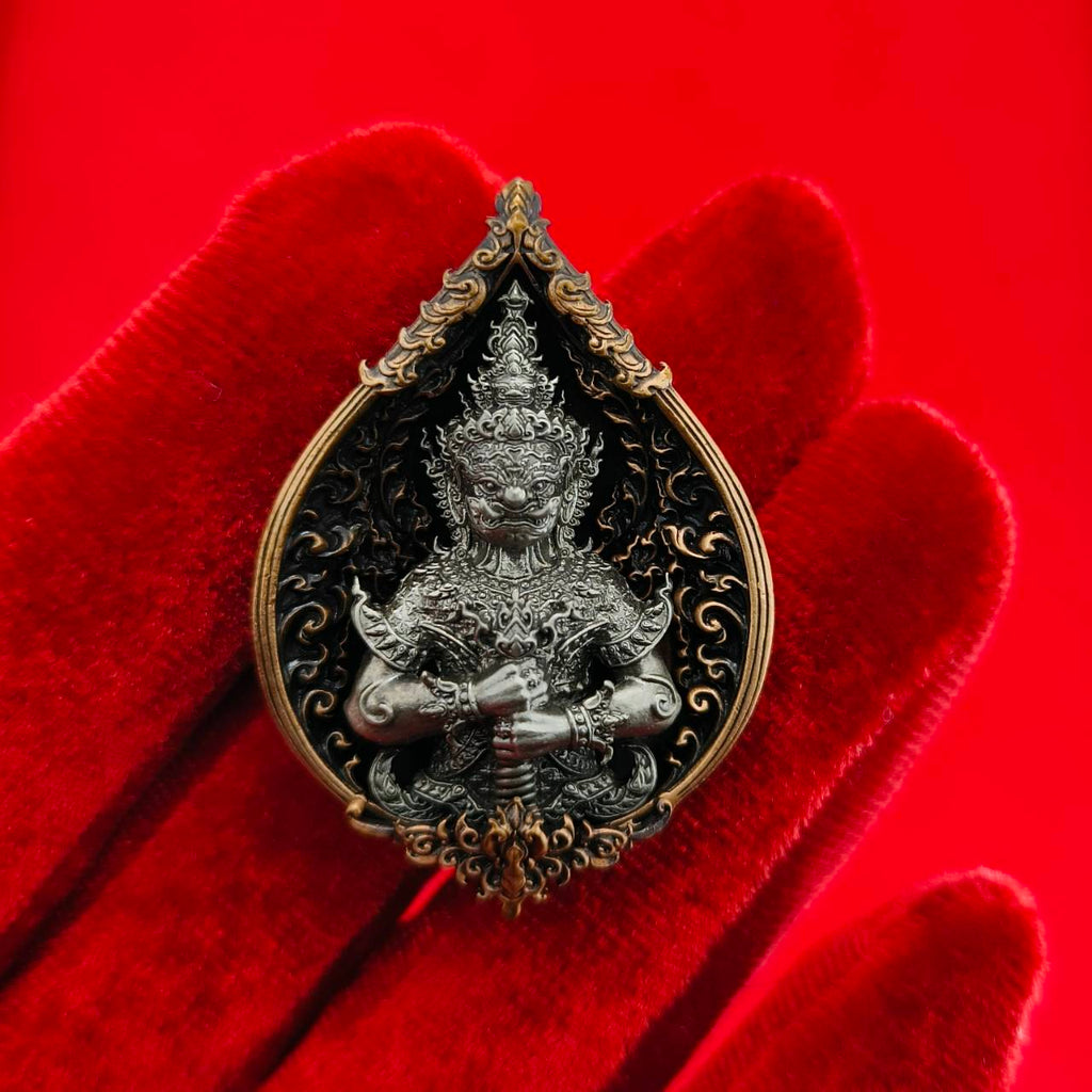 Thao Wessuwan amulet for wealth featuring intricate details and ornate design on a red background