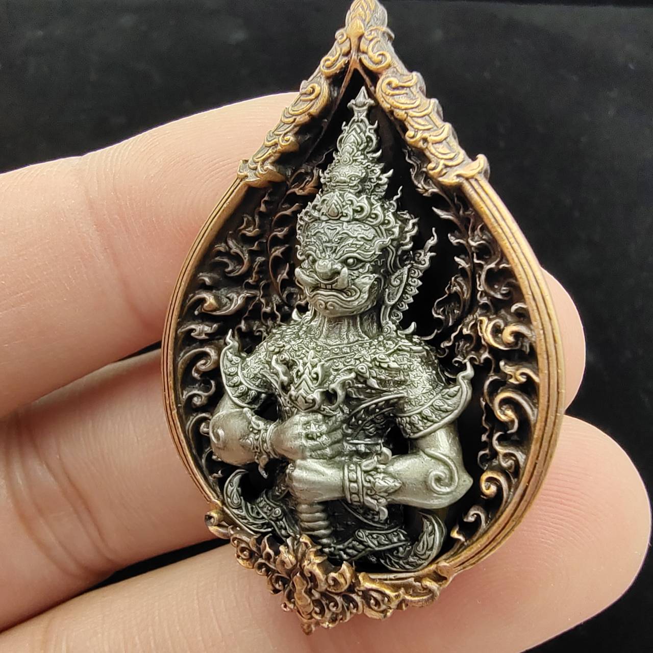 Thao Wessuwan amulet for wealth in intricately designed setting, ideal for spiritual decoration