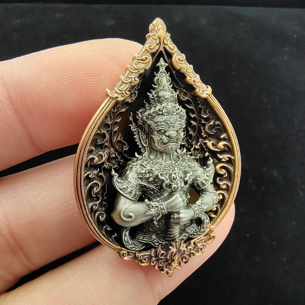 Thao Wessuwan amulet for wealth in decorative resin with intricate detailing held by hand