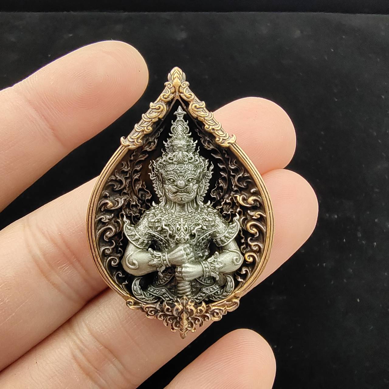 Thao Wessuwan amulet for wealth in intricate design, held in hand for spiritual blessings