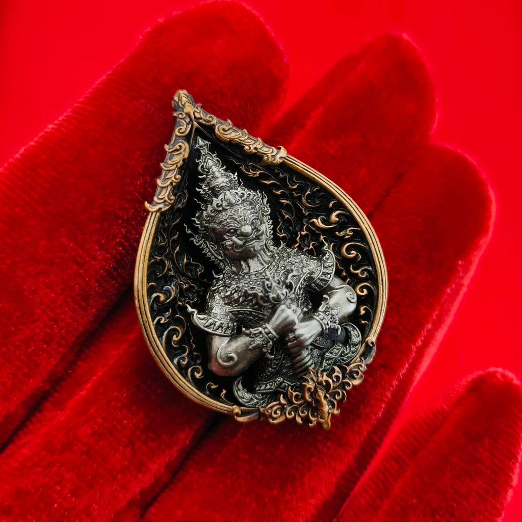 Thao Wessuwan amulet for wealth displayed on a plush red background with intricate detailing