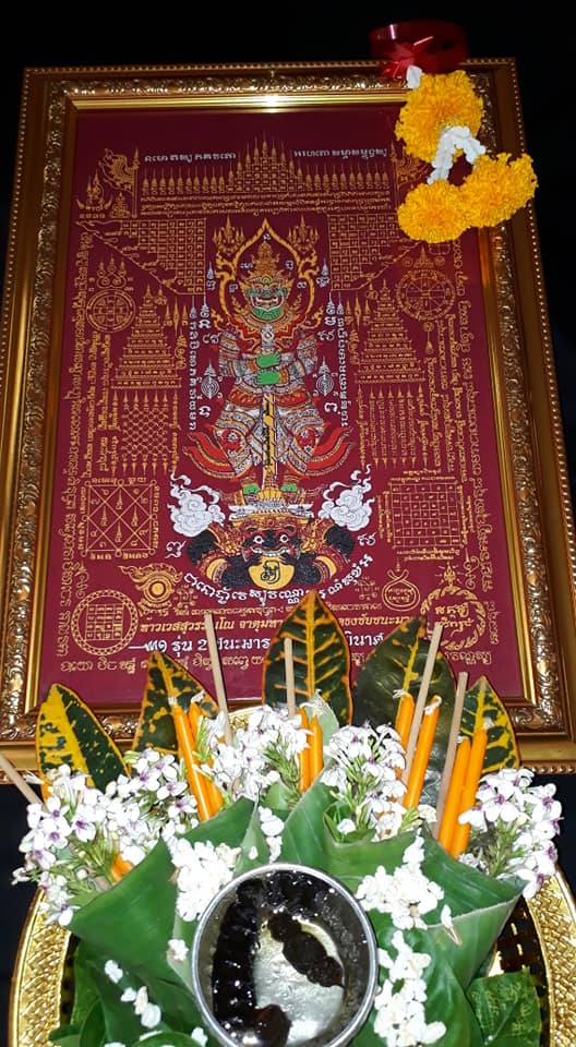 Thao Wessuwan yantra cloth featuring intricate gold designs on a rich red background for spiritual practice