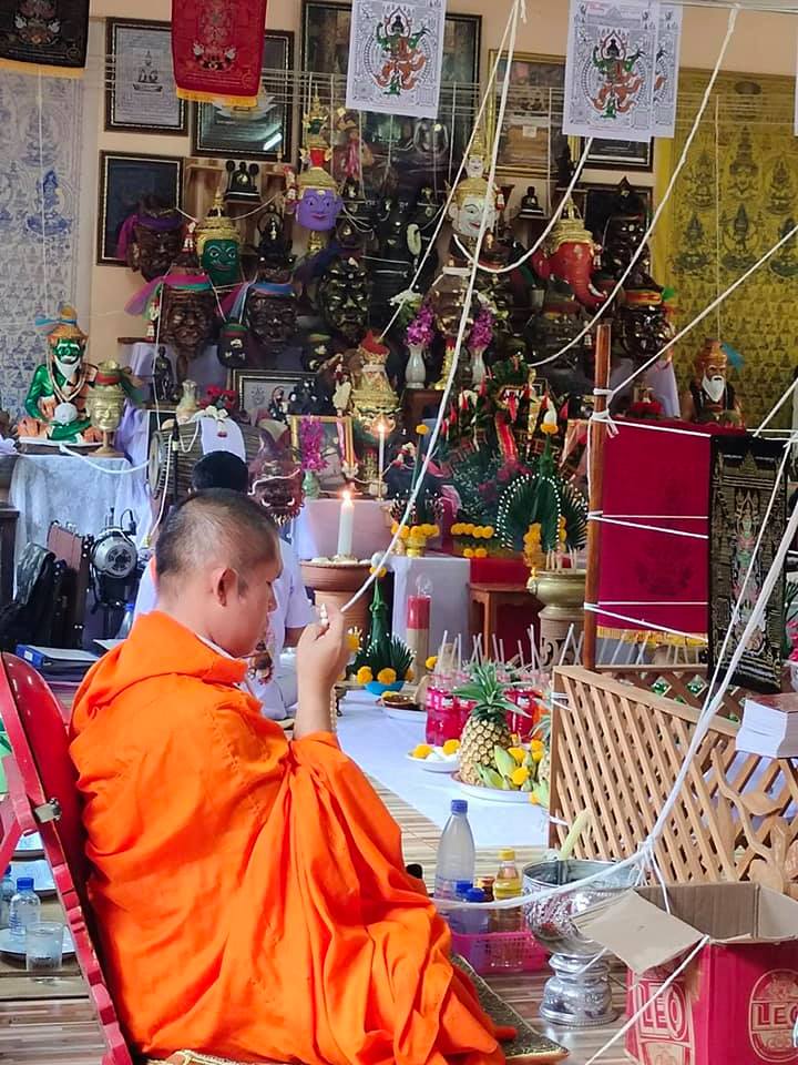 Thai Blessing Co monk performing ritual with Thao Wessuwan yantra cloth in a temple setting