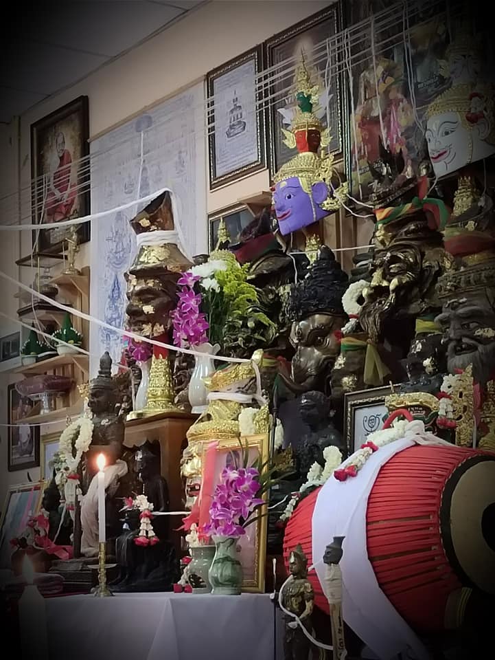 Thao Wessuwan yantra cloth displayed among traditional Thai deity statues and offerings