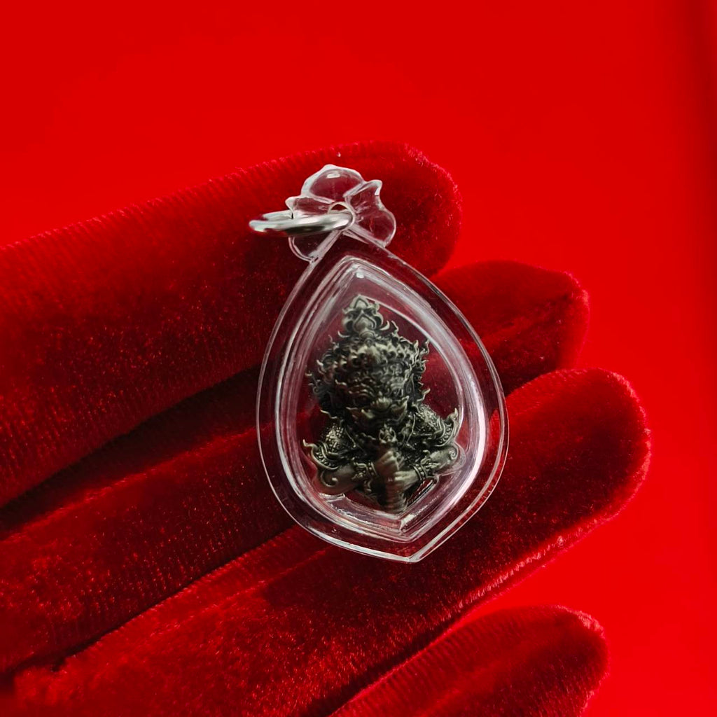 Thao Wessuwanno amulet in clear pendant holder, symbolizing protection and fortune in Thai culture