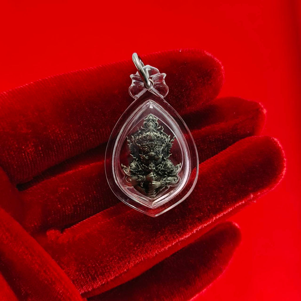 Thao Wessuwanno amulet in protective casing held in a hand, symbolizing spirituality and faith