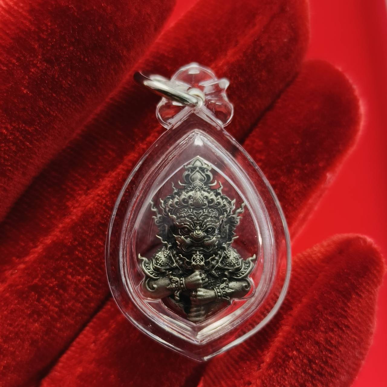 Thao Wessuwanno amulet in a clear protective casing, detailed design showcasing its spiritual significance