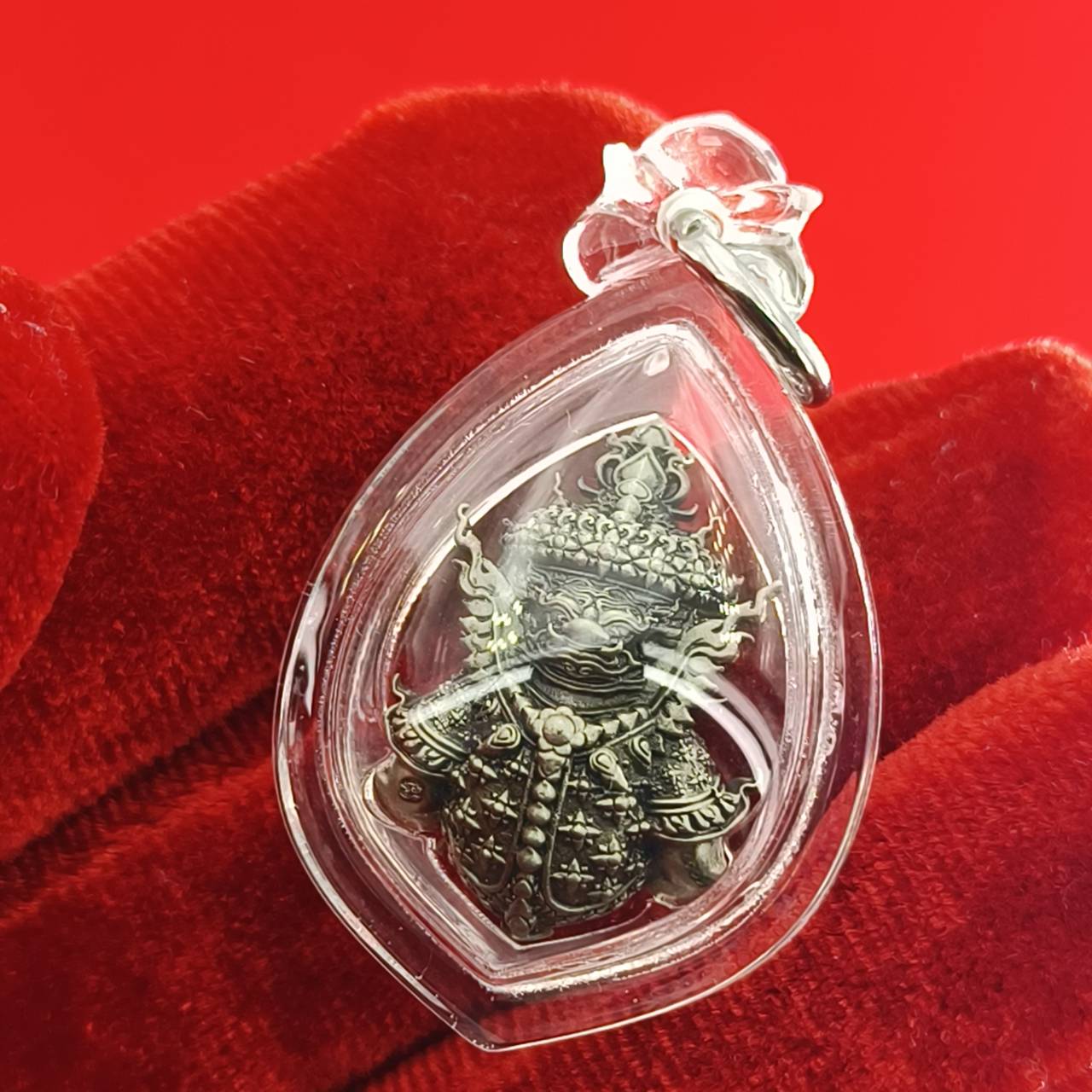 Thao Wessuwanno amulet encased in clear protective resin, featuring intricate details on the figure's attire