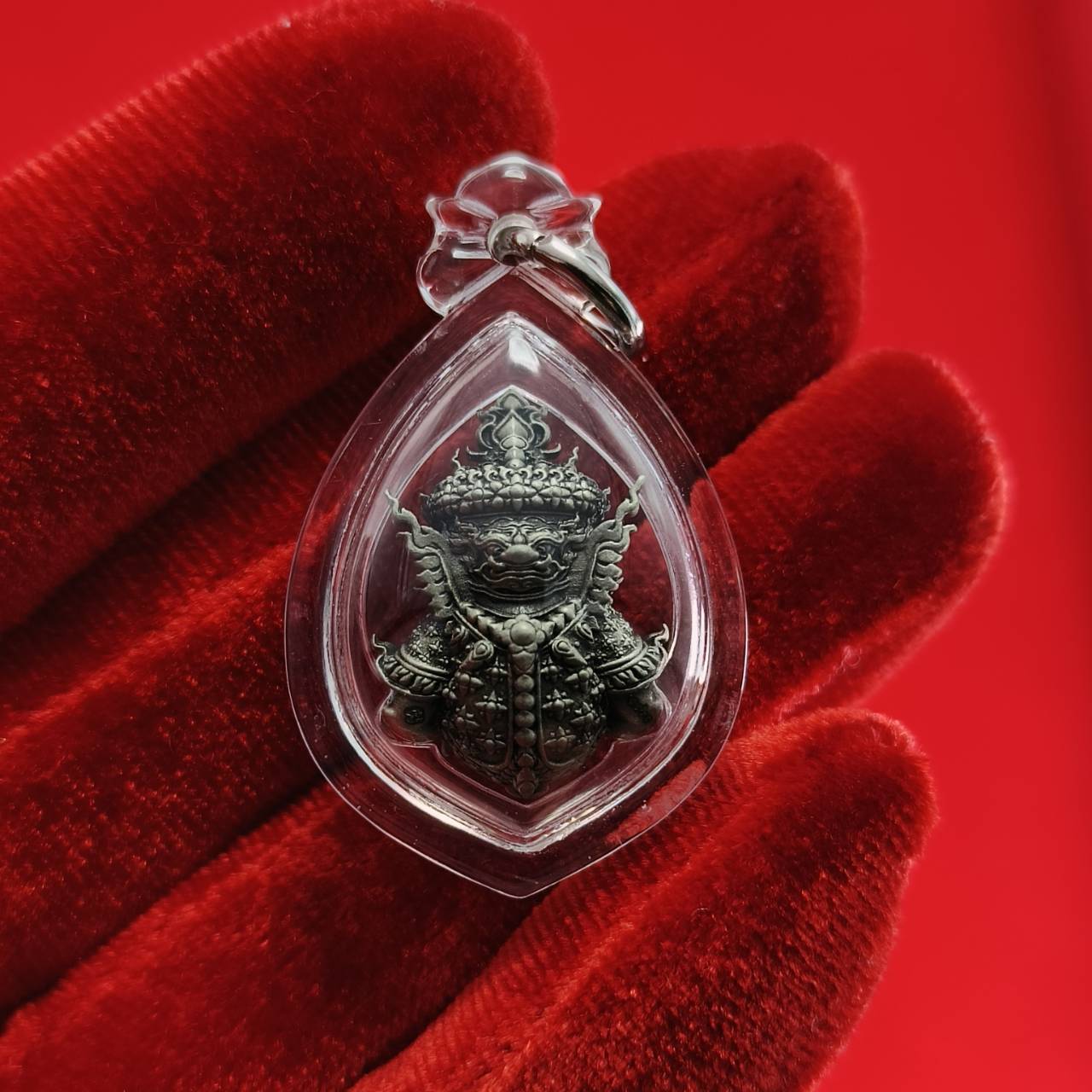 Thao Wessuwanno amulet in a clear pendant showcasing intricate details and craftsmanship