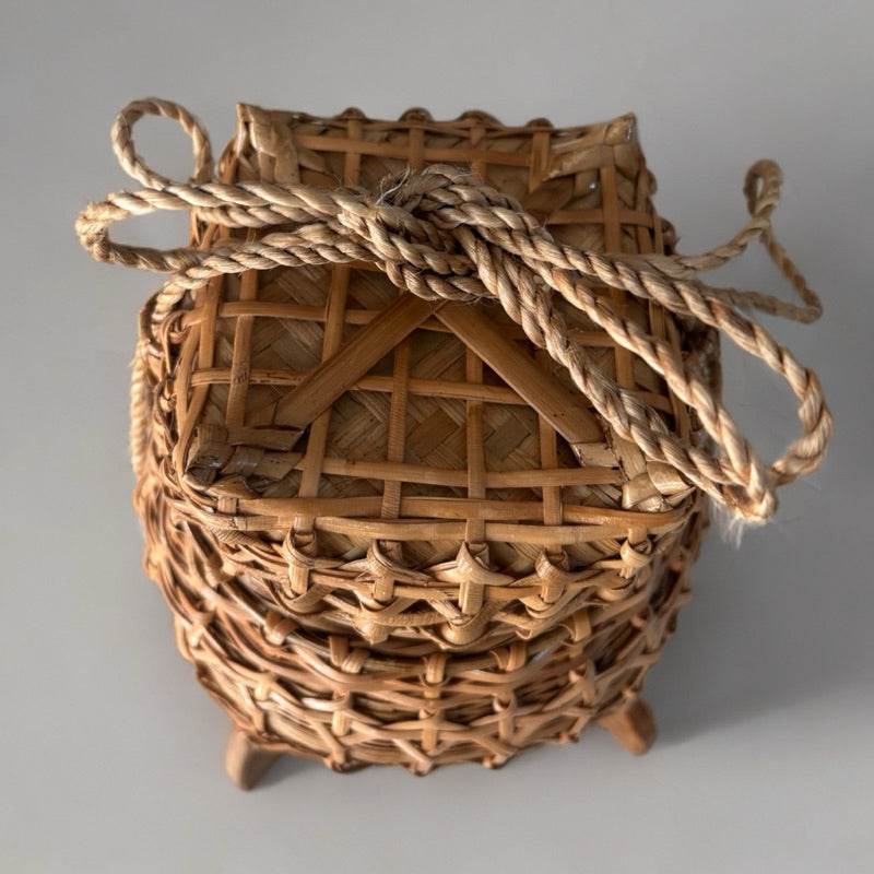 Handwoven traditional Thai storage box made of natural bamboo with rope handle
