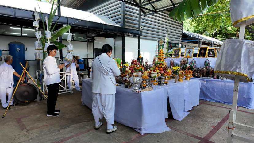 Ceremony setup featuring Trimurti Ganesha medallion for luck alongside offerings and decorations