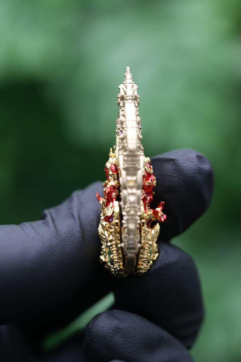 Side view of Trimurti Ganesha medallion for luck featuring intricate design and rich colors