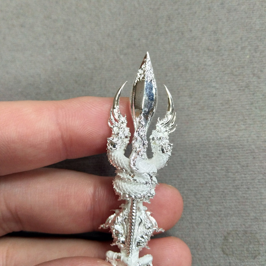 Unique Vajra Wessuwan amulet for wealth held in hand, intricately designed with dragon details