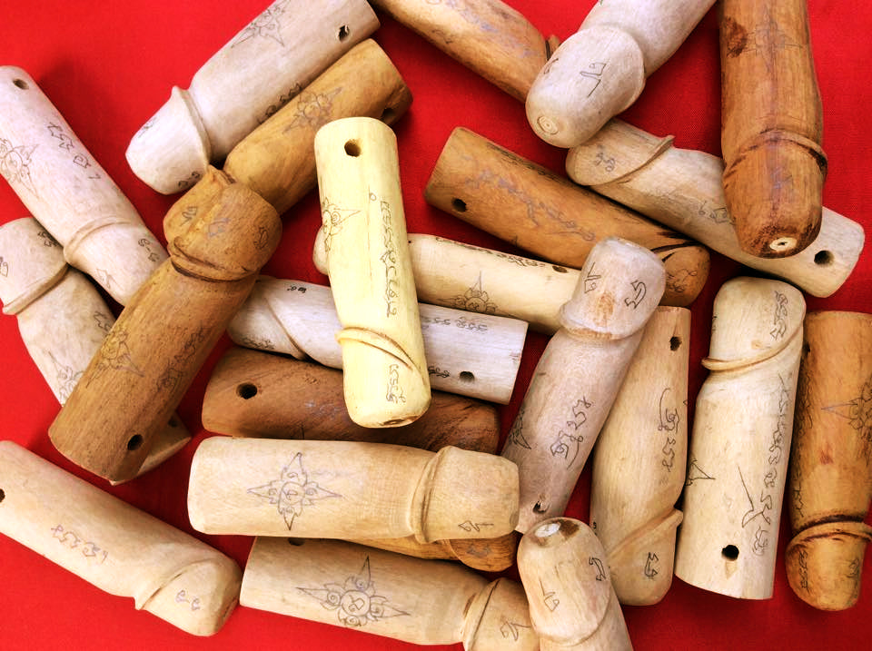 Collection of authentic palad khik amulets carved from wood for protection and good luck