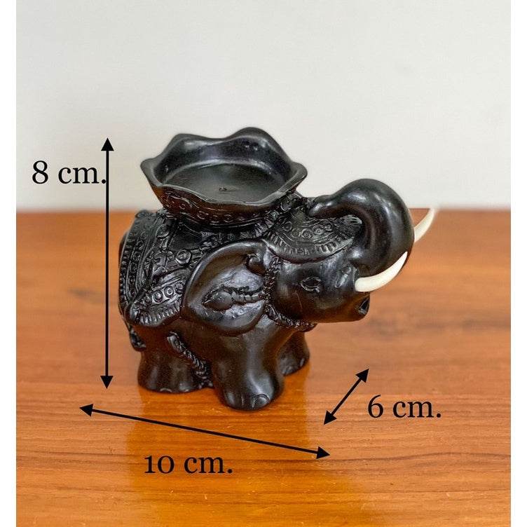 Handcrafted elephant tea light figurine in black with intricate details and candle holder on top